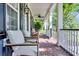 Relaxing front porch with brick flooring offers comfortable seating and serene views at 2720 Oak Manor Dr, Mount Pleasant, SC 29466