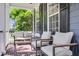 Charming front porch features cozy seating, brick flooring, and stylish design at 2720 Oak Manor Dr, Mount Pleasant, SC 29466
