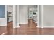 Elegant interior showcasing hardwood floors, white columns, and a glimpse of the kitchen at 2720 Oak Manor Dr, Mount Pleasant, SC 29466