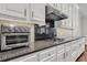 This kitchen offers sleek appliances, granite countertops, and ample storage with elegant white cabinets at 2720 Oak Manor Dr, Mount Pleasant, SC 29466