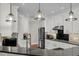 Modern kitchen featuring white cabinets, granite countertops, stainless steel appliances, and pendant lighting at 2720 Oak Manor Dr, Mount Pleasant, SC 29466