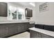 Laundry room features a stainless steel sink, grey cabinets, granite countertop and natural light at 2720 Oak Manor Dr, Mount Pleasant, SC 29466