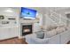Cozy living room featuring a fireplace, built-in shelving, hardwood floors and a comfortable sofa at 2720 Oak Manor Dr, Mount Pleasant, SC 29466