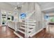 Bright living room features hardwood floors, staircase, a ceiling fan, and large windows letting in natural light at 2720 Oak Manor Dr, Mount Pleasant, SC 29466