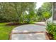 Backyard area featuring a patio with brick trim, manicured lawn, and lush trees at 2791 Gaston Gate, Mount Pleasant, SC 29466