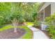 Side yard view showcasing a mulched planting bed, grass and walkway to the back of the home at 2791 Gaston Gate, Mount Pleasant, SC 29466