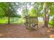 Backyard scene with play structure, pond, mature trees, and inviting natural surroundings at 2791 Gaston Gate, Mount Pleasant, SC 29466