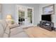 Cozy living room with hardwood floors, French doors leading to the deck, and a television on a dark wood stand at 2791 Gaston Gate, Mount Pleasant, SC 29466