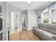 Cozy room features hardwood floors, a gray sofa, a door, and a view into another room at 2791 Gaston Gate, Mount Pleasant, SC 29466
