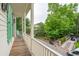 Inviting balcony showcasing a wood deck, charming rocking chair, and neighborhood views at 28 Robert Mills Cir, Mount Pleasant, SC 29464