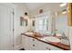 Bathroom featuring a double sink vanity with wooden counters, a window, and plenty of storage space at 28 Robert Mills Cir, Mount Pleasant, SC 29464