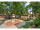 Serene courtyard showcasing a brick patio, ornate fountain, and landscaped garden at 28 Robert Mills Cir, Mount Pleasant, SC 29464