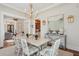 Dining room features a table, white chairs, chandelier, and a view into the butler's pantry at 28 Robert Mills Cir, Mount Pleasant, SC 29464
