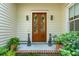 Welcoming front entrance with double doors, potted greenery, and charming decor at 28 Robert Mills Cir, Mount Pleasant, SC 29464