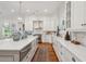 Bright kitchen boasts white cabinetry, marble countertops, stainless steel appliances, and a herringbone backsplash at 28 Robert Mills Cir, Mount Pleasant, SC 29464