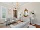 Formal living room with tufted sofas, chandelier, and a double door entryway for added character at 28 Robert Mills Cir, Mount Pleasant, SC 29464