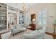 Sitting room features stylish couches, a chandelier, built in shelves, and hardwood floors at 28 Robert Mills Cir, Mount Pleasant, SC 29464