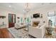 Bright living room with fireplace, large rug, stylish sofas, and elegant chandelier perfect for entertaining guests at 28 Robert Mills Cir, Mount Pleasant, SC 29464
