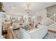 Open-concept living room with staircase, hardwood floors, fireplace and view into the kitchen, ideal for entertaining at 28 Robert Mills Cir, Mount Pleasant, SC 29464