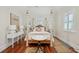 Bright main bedroom features a king bed, hardwood floors, a patterned area rug, and plenty of lighting at 28 Robert Mills Cir, Mount Pleasant, SC 29464