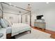 This spacious main bedroom features a king bed, hardwood floors, a patterned area rug, and a decorative lighting fixture at 28 Robert Mills Cir, Mount Pleasant, SC 29464