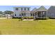 Expansive backyard featuring a patio with seating, lush green grass, and a charming home exterior at 2828 Wagner Way, Mount Pleasant, SC 29466