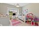 Cozy bedroom featuring twin beds, a bright window view, and playful decor with a dollhouse at 2828 Wagner Way, Mount Pleasant, SC 29466