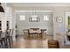 Bright dining room features a rustic wooden table with seating for six, adjacent to living room at 2828 Wagner Way, Mount Pleasant, SC 29466