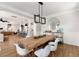 Open dining room featuring wood table, modern light fixture, and stylish decor flowing to the living room at 2828 Wagner Way, Mount Pleasant, SC 29466