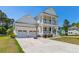 Stunning two-story home with a welcoming front porch and a spacious three-car garage for ample parking at 2828 Wagner Way, Mount Pleasant, SC 29466