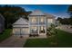 Elegant two-story house with a charming front porch and a spacious garage, illuminated by warm exterior lighting at 2828 Wagner Way, Mount Pleasant, SC 29466