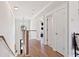 Upstairs hallway with hardwood floors, white trim, and natural light leading to bedrooms at 2828 Wagner Way, Mount Pleasant, SC 29466