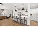Open concept kitchen with white cabinetry, a large island, and hardwood flooring, flowing into living space at 2828 Wagner Way, Mount Pleasant, SC 29466