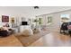 Bright living room featuring hardwood floors, two large windows, and creative decor with unique accents at 2828 Wagner Way, Mount Pleasant, SC 29466