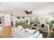 Bright open concept living space showcases a modern kitchen and stylish decor with a fan and wood floors at 2828 Wagner Way, Mount Pleasant, SC 29466