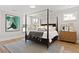 Inviting main bedroom featuring a four-poster bed, neutral decor, artwork and hardwood floors at 2828 Wagner Way, Mount Pleasant, SC 29466
