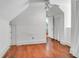 Spacious attic featuring hardwood floors, a ceiling fan, and an open doorway at 29 Smith St, Charleston, SC 29401