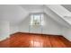 Empty attic room with hardwood floors and a window with natural light at 29 Smith St, Charleston, SC 29401