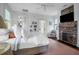 Large bedroom with a brick fireplace and multiple windows with beautiful light at 29 Smith St, Charleston, SC 29401