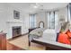 Cozy bedroom with a decorative fireplace, neutral carpet, and natural light at 29 Smith St, Charleston, SC 29401