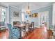 Charming dining room with wood floors, beautiful light fixture, and blue accent walls at 29 Smith St, Charleston, SC 29401