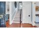 Welcoming entryway boasts hardwood floors and staircase leading to the upper level at 29 Smith St, Charleston, SC 29401