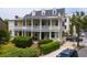 Charming yellow two-story home featuring a double veranda and manicured landscaping at 29 Smith St, Charleston, SC 29401