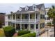 Beautiful yellow two-story home with a double veranda and well-maintained landscaping at 29 Smith St, Charleston, SC 29401