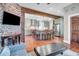 Open-concept living space featuring a brick accent wall and an eat-in kitchen with a central island at 29 Smith St, Charleston, SC 29401
