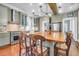 Eat-in kitchen with a central island, seating, stainless steel appliances, and custom cabinetry at 29 Smith St, Charleston, SC 29401