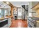 Kitchen with a spiral staircase and brick fireplace at 29 Smith St, Charleston, SC 29401
