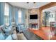 Inviting living room with a brick accent wall, comfortable seating, and access to a spiral staircase at 29 Smith St, Charleston, SC 29401