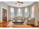 Cozy living room with bay windows, plush seating, and a ceiling fan at 29 Smith St, Charleston, SC 29401