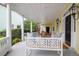 Inviting covered porch with seating, ceiling fan, and view of the street at 29 Smith St, Charleston, SC 29401